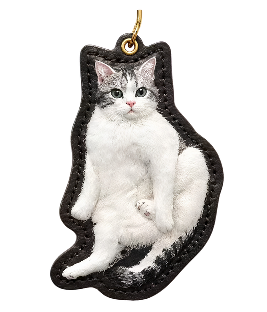 Custom pet figurine keychain with black-and-white cat figurine, black leather strap and ring