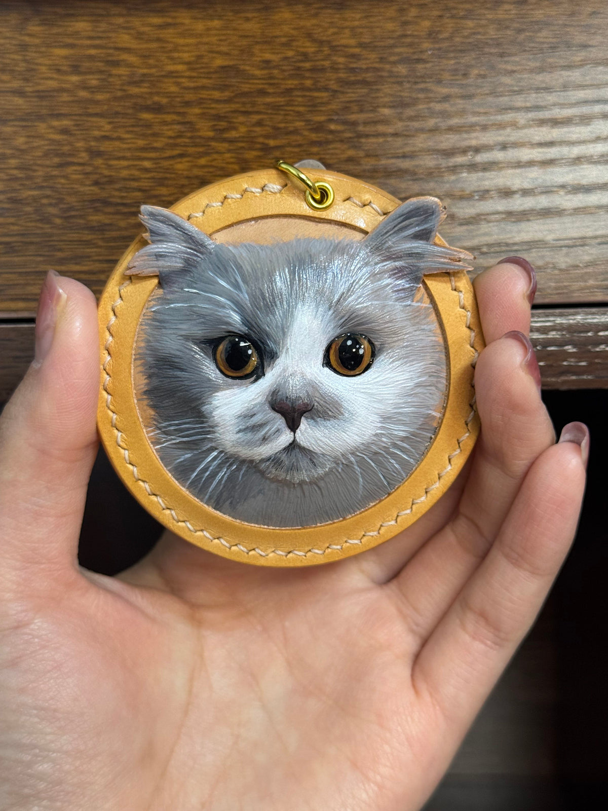 Cat face key ring ornament with tan stitched leather pouch and gold ring clasp