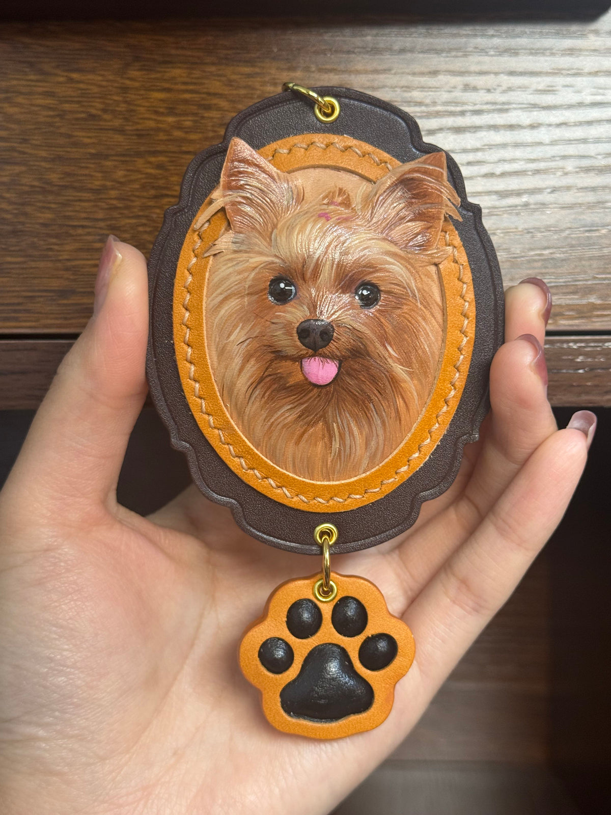 Dog face key ring ornament in dark felt with tan leather and paw charm