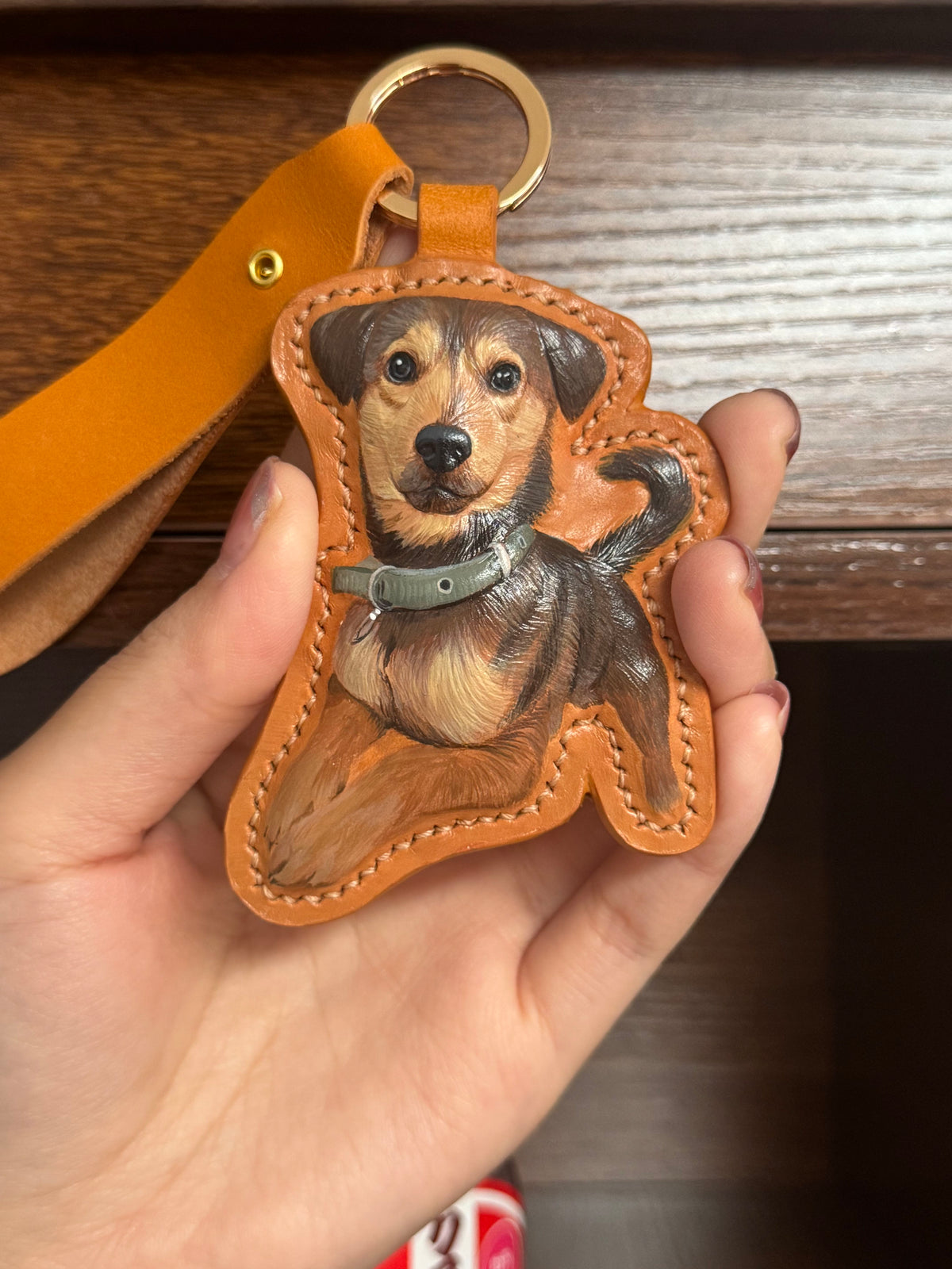 Brown dog figurine leather keychain with gold ring and stitched pocket detail