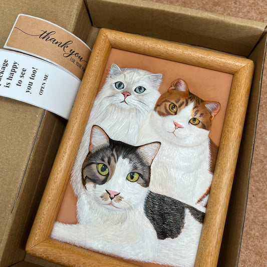Custom handmade leather pet photo panel with cat portraits, set in a wooden frame