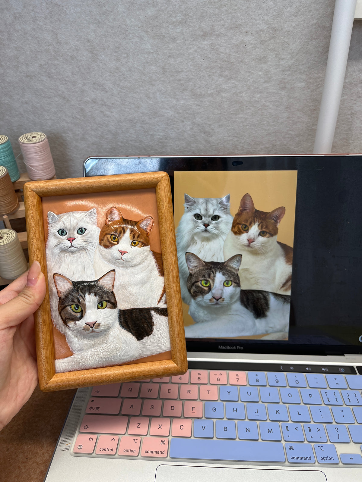 Custom handmade leather pet photo charm with stitched oval frame, featuring four cat faces
