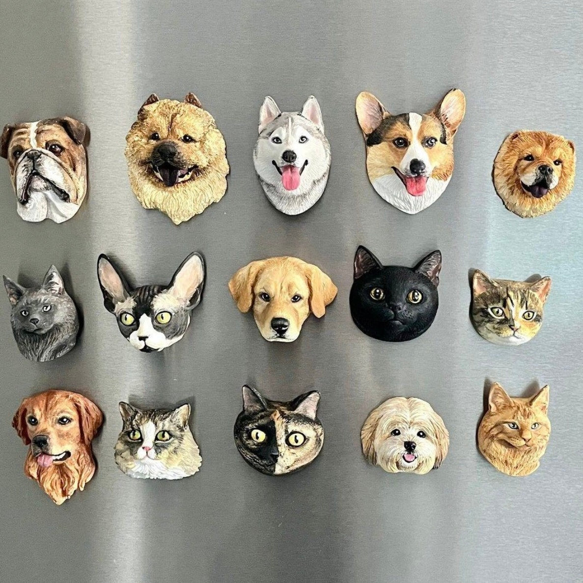3D pet fridge magnets display—many animal face designs arranged in rows on a board.