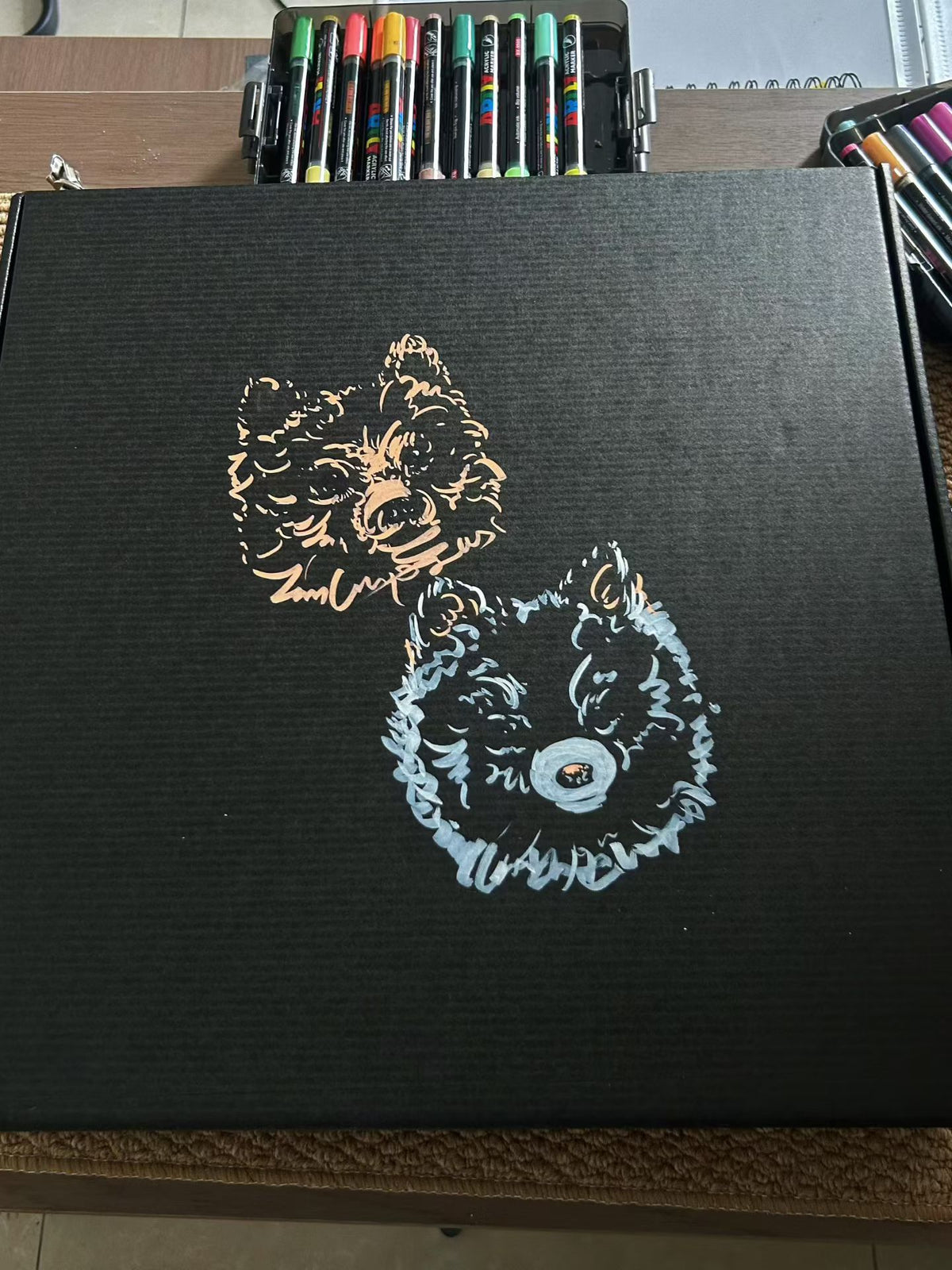 Scratchboard pet portrait panel with golden dog illustration on dark surface